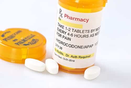 An unlabeled pill bottle illustrates drugs in america