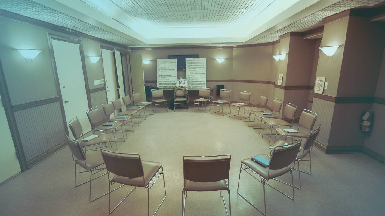 A group meeting room with empty chairs in a circle